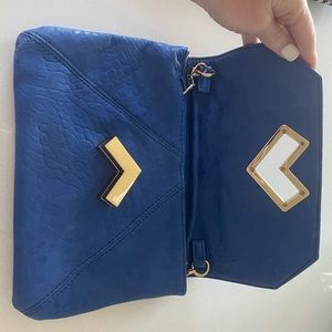 Blue clutch. Good condition. Comes with shoulder strap.
